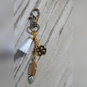 Four Leaf Clover And Feather Bag Charm With Tassel